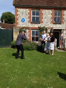 L to R:  James Lovegrove, Author of “Sherlock Holmes Gods of War”; Eastbourne Borough Council Cabinet Member for Tourism, Leisure & Sports Services, Cllr Carolyn Heaps; and Sarah Leighton of the Beachy Head Estate at the launch of the new Sherlock Holmes book.  The launch took place on East Dean village green in front of the blue plaque on the wall of the Beachy Head Estate Office honouring the celebrated detective.