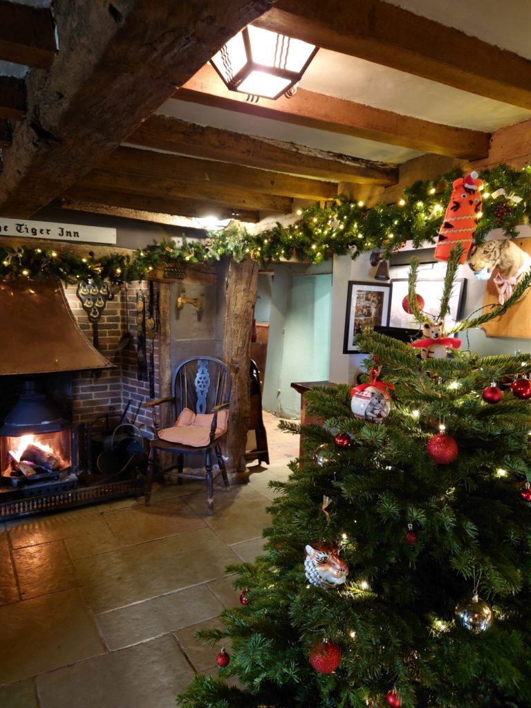 Relax in the pub at Christmas with a drink by the fire.